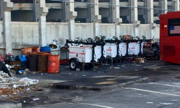 Proposal: Parade To Celebrate How Good RIOC Is At Spending Your Money Excess inventory generators soaking up sun behind parked buses.